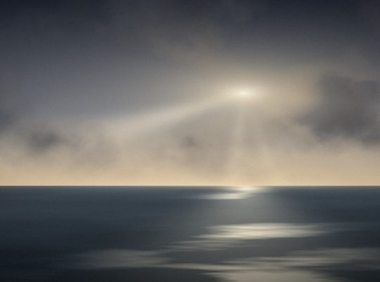 Light breaking through storm clouds over the sea, a picture of trusting God in hard times