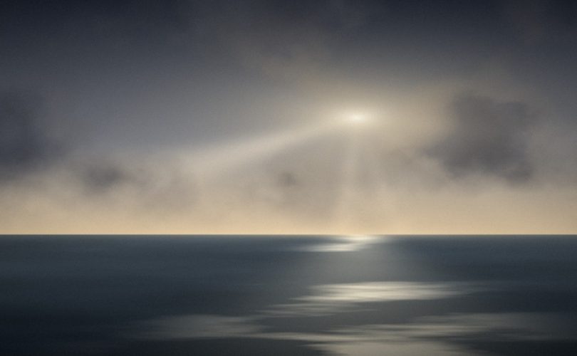 Light breaking through storm clouds over the sea, a picture of trusting God in hard times